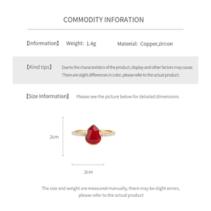 Detail view of 18k gold plated gourd ring with red enamel inlay and zircon accents