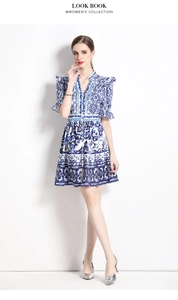 Full view of blue and white Majolica print V-neck dress with ruffled short sleeves