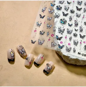Close-up of butterfly nail art stickers with iridescent blue patterns and 3D effects