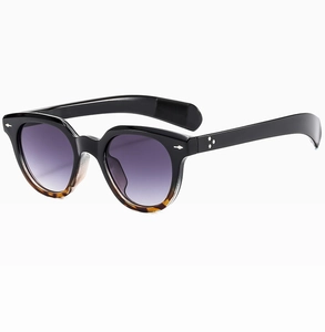 Detail view of retro oval sunglasses with star-shaped rivets and tortoise shell frame