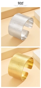 Detail showing irregular bark texture on gold and silver wide C-shape stainless steel bangles