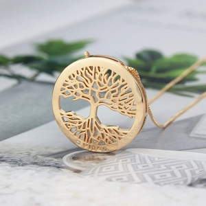 Macro shot of 18k gold plated Tree of Life pendant with VIDA engraving and sleek chain