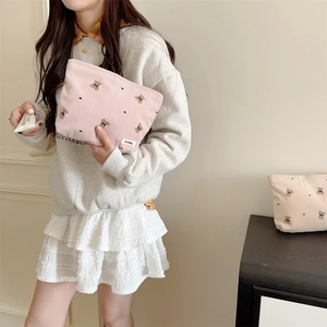 Detailed embroidery of a cute bear on pink corduroy cosmetic storage bag