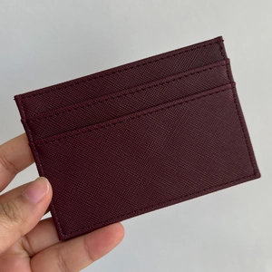 Detail of burgundy Saffiano leather card holder showing precise stitching and card slots