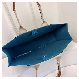 Detailed top view of large navy felt tote bag interior showing magnetic closure and capacity