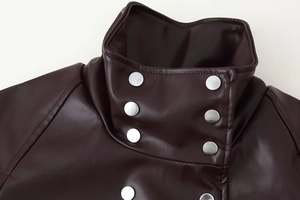 Close-up of dark brown PU leather jacket with double-breasted buttons and pebbled texture