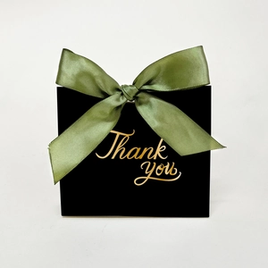Elegant black gift box with olive green ribbon and golden Thank You calligraphy