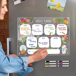 Close-up of magnetic acrylic weekly planner on fridge with festive Christmas designs