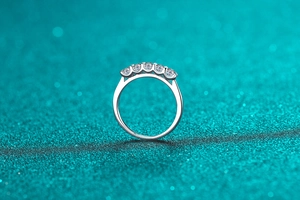Macro shot of S925 sterling silver ring with five sparkling round cut moissanite stones