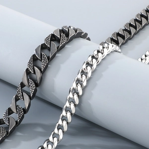Macro view of textured dark gray and polished silver stainless steel cuban link chains