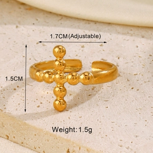 Detail of adjustable gold cross open ring showing 1.7cm diameter on stone base