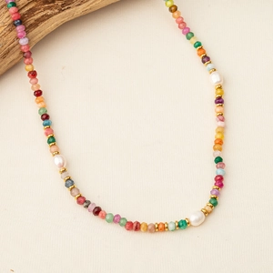 Bohemian colorful natural stone and pearl beaded necklace on a wooden jewelry display