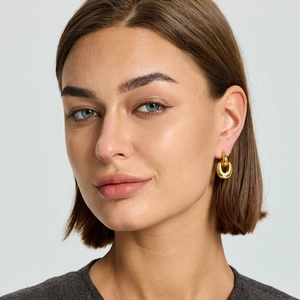 18K gold plated stainless steel geometric link earrings shown on a model