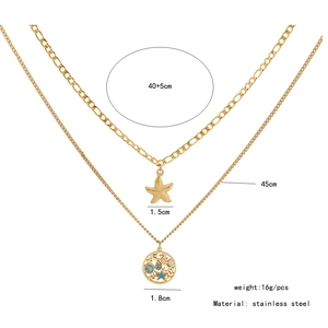 Detail view of double-layer gold stainless steel necklace with starfish and star pendants
