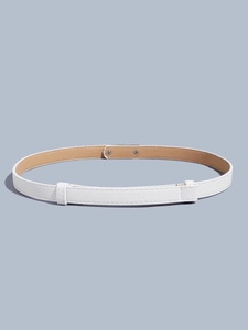 Detail of white cross-textured slim belt featuring dual loops and silver metal rivets