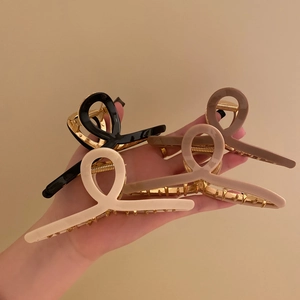 Minimalist metal hair claw clips in black, beige, and brown colors for women's hairstyling