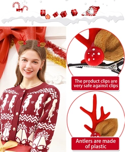Detail of red Christmas antler hair clips with bells and plush pom poms for women