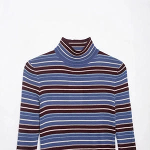 Women's turtleneck knit sweater featuring classic multi-color horizontal stripes