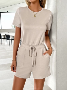 Detail of beige short sleeve top and casual shorts with drawstring waist and pockets