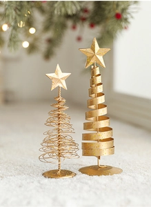 Close-up of golden iron Christmas tree ornaments with glitter details on warm background