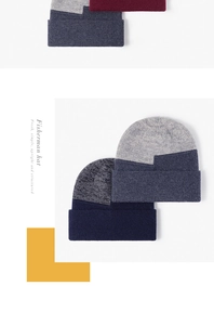 Detailed close-up of thick ribbed knit texture on a dual-tone fisherman beanie