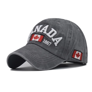 Close-up of white CANADA embroidery and maple leaf flag on washed grey cotton cap