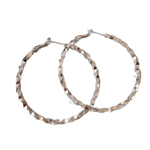 Textured silver hoop earrings with a geometric diamond-cut design for women
