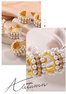 Detailed close-up of gold hoop earrings featuring rows of white pearls and sparkling rhinestones