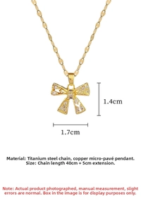 Detailed close-up of a gold bow pendant necklace with sparkling micro-pave crystals