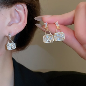 Detail of padlock earrings with rectangular zircon and micro-pave crystals