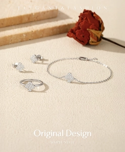 Elegant jewelry set with S925 silver poker club ring, earrings and bracelet on a stone