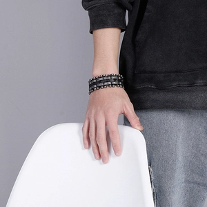 Detail of mens stainless steel braided leather bracelet in retro silver and black colors