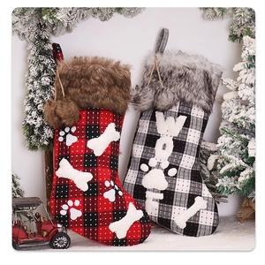 Close-up of plaid Christmas stockings with faux fur trim and cute bone-shaped pet charms