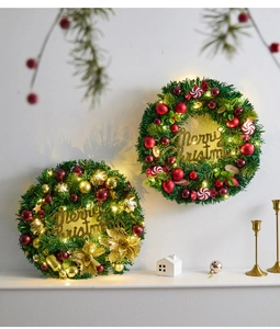 Detail of Christmas wreath with LED lights, golden flowers and Merry Christmas sign