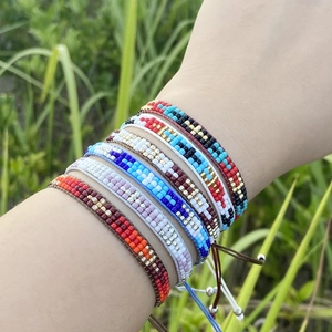 Bohemian woven smiley face letter seed bead bracelets set for women on green grass