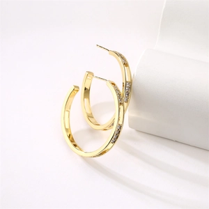 Elegant gold C-shaped hoop earrings featuring micro-pave cubic zirconia accents