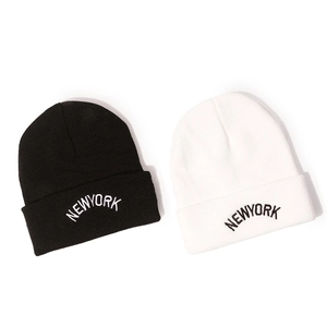 Winter knitted beanie hats in black and white featuring NEW YORK embroidery for men and women