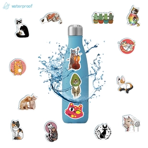 Waterproof cartoon cat stickers shown on a blue water bottle with splashes for durability