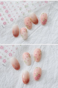 Close-up of 5D Japanese cherry blossom nail stickers with pink gradient and floral relief