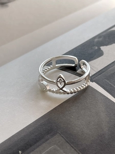 Detailed macro view of S925 silver double-layered ring with fish symbol and beaded band