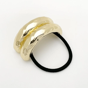 Detail of minimalist gold irregular metal ring hair tie with black elastic rope