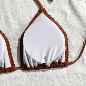 Detail of rust red crinkle bikini top showing white mesh lining and removable round pads