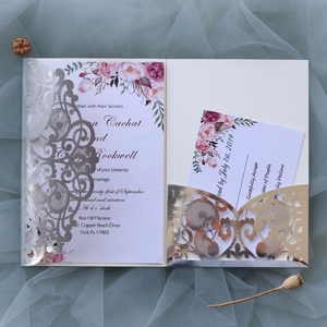 Detail of laser-cut silver wedding invitation with floral inner cards and RSVP card set