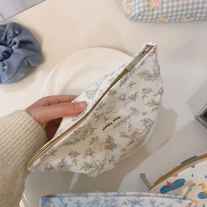 Detailed close-up showing the cotton fabric texture and interior of small duck pouch