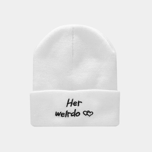 Close-up of white ribbed knit beanie with Her Weirdo embroidery and heart detail