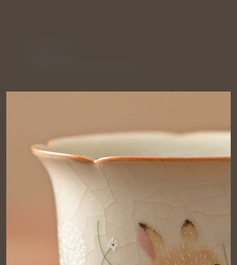 Macro detail of Ru kiln ceramic teacup featuring ice crackle glaze and red petal rim