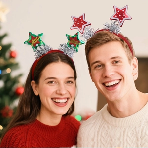 Close-up of children wearing festive Merry Christmas star headbands with tinsel decorations