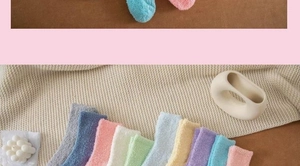 Close-up of assorted colorful thick coral fleece socks displayed on a cozy knit blanket