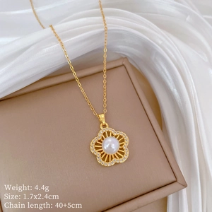 Detailed view of golden flower necklace with pearls and crystal inlay on silk fabric