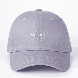 Close-up of NOT REALLY embroidery on gray-purple cotton canvas baseball cap